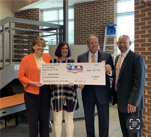 Sandi Sellers with oversized check and prize patrol